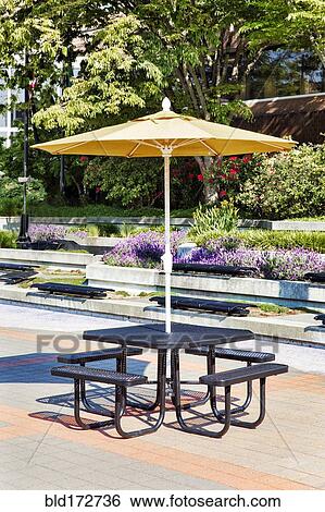 Stock Photograph - Empty picnic table in courtyard. Fotosearch