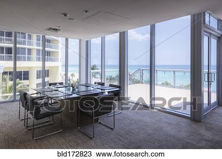 Stock Image - Empty table in office meeting room. Fotosearch