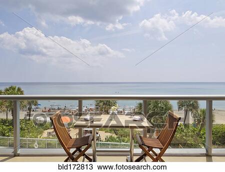 Empty table on restaurant balcony overlooking beach View Large Photo Image Stock Image - Empty table on restaurant balcony overlooking beach. Fotosearch