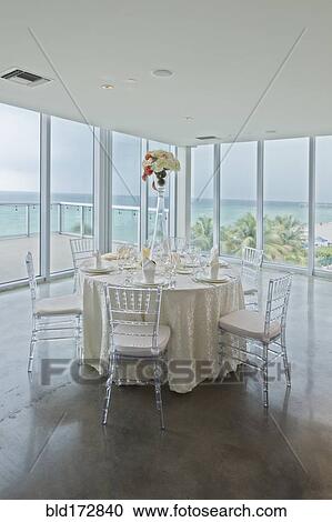 Stock Image - Empty tables in banquet hall. Fotosearch