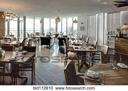 Stock Image - Empty tables in restaurant. Fotosearch