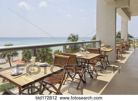 Empty tables on restaurant balcony View Large Photo Image Stock Image - Empty tables on restaurant balcony. Fotosearch