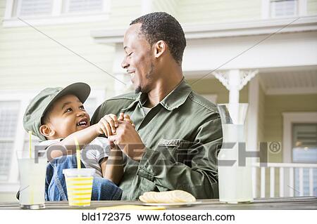 Father and son relaxing in backyard View Large Photo Image Stock Photography - Father and son relaxing in backyard. Fotosearch