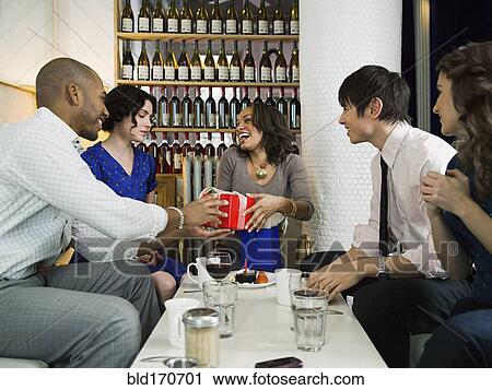 Friends celebrating birthday in restaurant View Large Photo Image Stock Image - Friends celebrating birthday in restaurant. Fotosearch