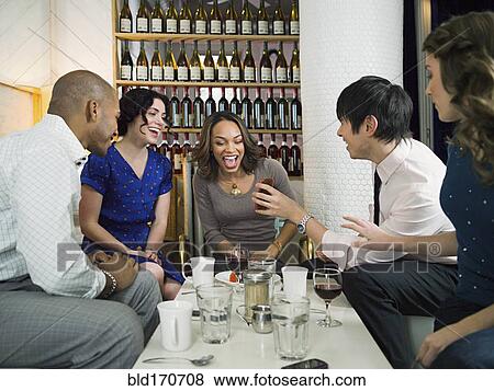 Stock Photo - Friends celebrating birthday in restaurant. Fotosearch