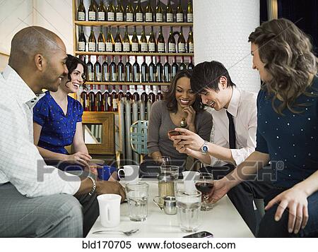Stock Photography - Friends celebrating birthday in restaurant. Fotosearch
