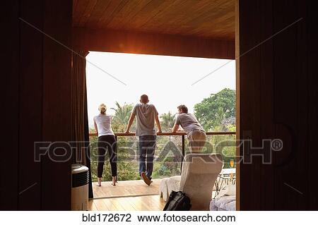 Friends standing on balcony View Large Photo Image Stock Image - Friends standing on balcony. Fotosearch