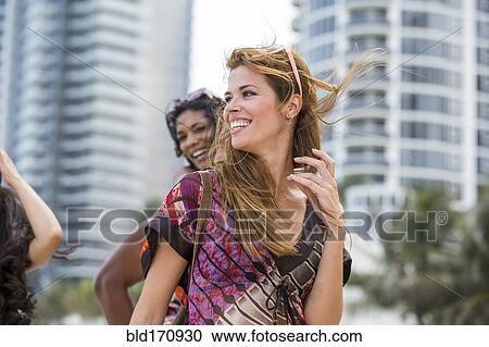 Friends walking on urban beach View Large Photo Image Stock Image - Friends walking on urban beach. Fotosearch