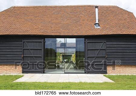Glass sliding doors of converted barn home View Large Photo Image Stock Photography - Glass sliding doors of converted barn home. Fotosearch