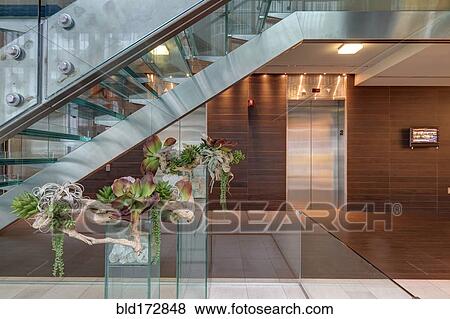 Glass staircase and elevators in hotel lobby View Large Photo Image Stock Photo - Glass staircase and elevators in hotel lobby. Fotosearch