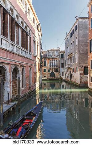 Stock Image - Gondola sailing in Venice canal, Veneto, Italy. Fotosearch