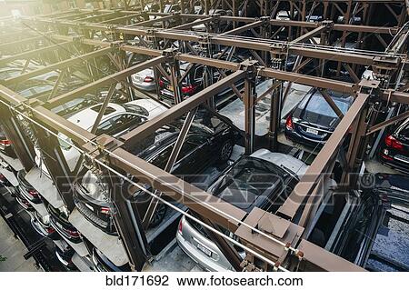 Stock Image - High angle view of cars parked in elevated garage. Fotosearch