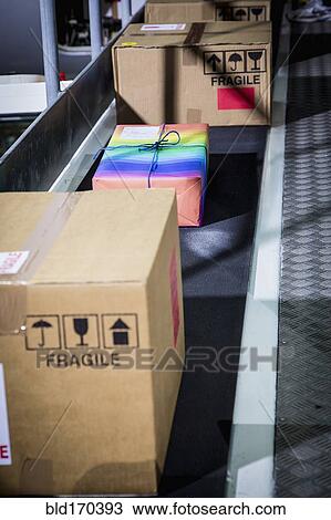 High angle view of colorful package on conveyor belt View Large Photo Image Stock Image - High angle view of colorful package on conveyor belt. Fotosearch