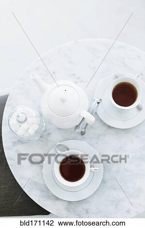 High angle view of cups of coffee on table View Large Photo Image Stock Image - High angle view of cups of coffee on table. Fotosearch
