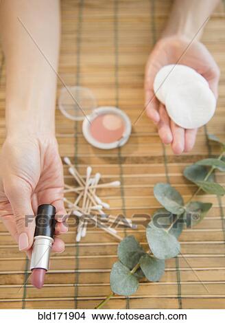 Picture - High angle view of mixed race woman holding makeup. Fotosearch