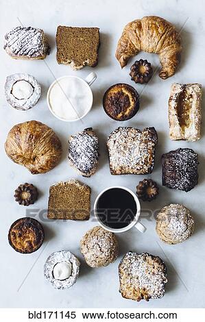 Stock Photography - High angle view of variety of pastries and coffee. Fotosearch