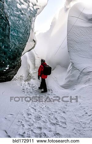 Hiker walking in snowy ice cave View Large Photo Image Stock Image - Hiker walking in snowy ice cave. Fotosearch