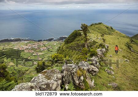 Hiker walking on hilltop path in rural landscape View Large Photo Image Stock Photo - Hiker walking on hilltop path in rural landscape. Fotosearch