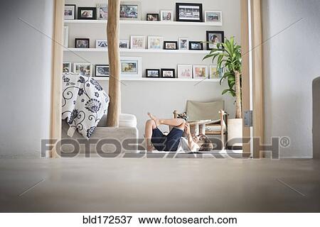 Hispanic boy playing on living room floor View Large Photo Image Stock Photo - Hispanic boy playing on living room floor. Fotosearch