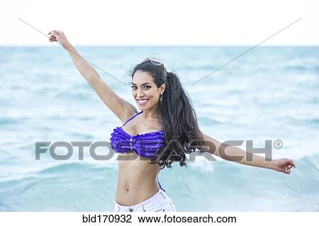 Hispanic woman playing in ocean View Large Photo Image Stock Image - Hispanic woman playing in ocean. Fotosearch