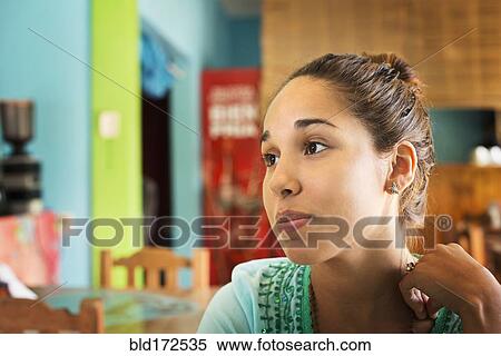 Hispanic woman sitting in cafe View Large Photo Image Stock Photography - Hispanic woman sitting in cafe. Fotosearch