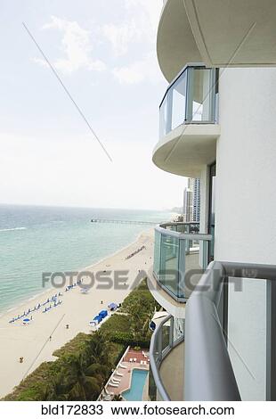 Stock Image - Hotel balcony overlooking urban beach. Fotosearch