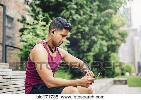 Indian athlete timing himself in city View Large Photo Image Stock Photography - Indian athlete timing himself in city. Fotosearch