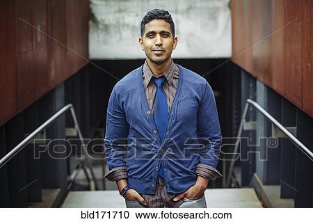 Stock Image - Indian businessman standing on office steps. Fotosearch