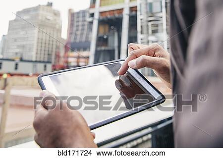 Indian businesswoman using digital tablet outdoors View Large Photo Image Picture - Indian businesswoman using digital tablet outdoors. Fotosearch