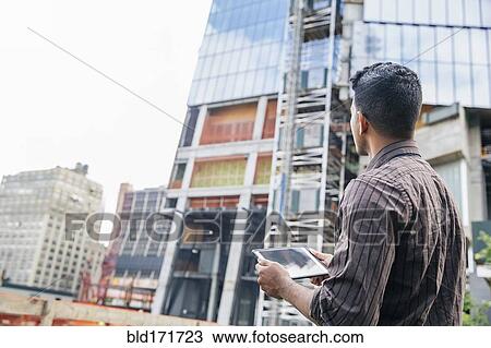 Indian businesswoman using digital tablet outdoors View Large Photo Image Stock Image - Indian businesswoman using digital tablet outdoors. Fotosearch