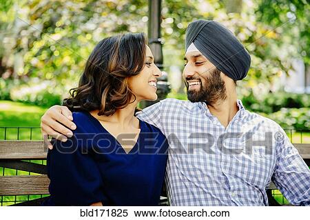 Indian couple hugging on bench in urban park View Large Photo Image Stock Photography - Indian couple hugging on bench in urban park. Fotosearch