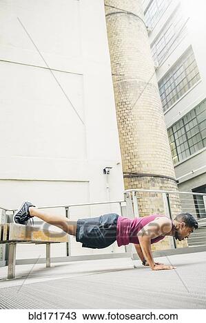 Indian man doing push-ups on bench View Large Photo Image Stock Image - Indian man doing push-ups on bench. Fotosearch