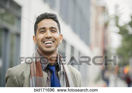 Stock Photograph - Indian man smiling in city. Fotosearch