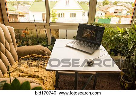 Laptop and mouse by armchair at desk View Large Photo Image Stock Image - Laptop and mouse by armchair at desk. Fotosearch