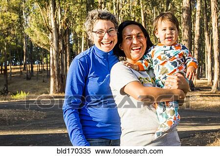 Lesbian couple holding baby in park View Large Photo Image Stock Photography - Lesbian couple holding baby in park. Fotosearch