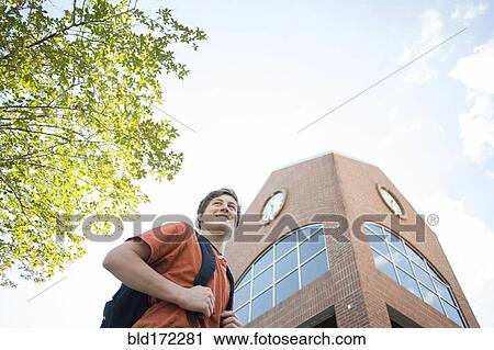 Low angle view of Caucasian teenage boy walking outdoors View Large Photo Image Stock Image - Low angle view of Caucasian teenage boy walking outdoors. Fotosearch
