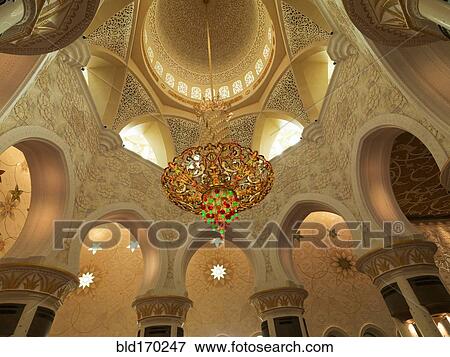 Stock Photo - Low angle view of chandelier in ornate dome, Abu Dhabi, Abu Dhabi Emirate, United Arab Emirates. Fotosearch
