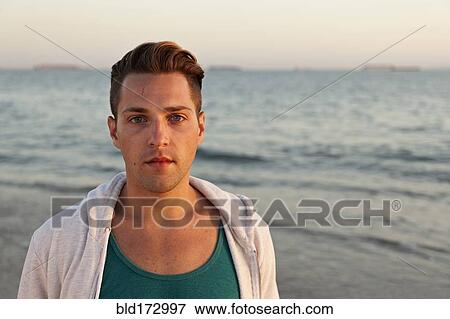 Stock Photo - Man standing on beach. Fotosearch