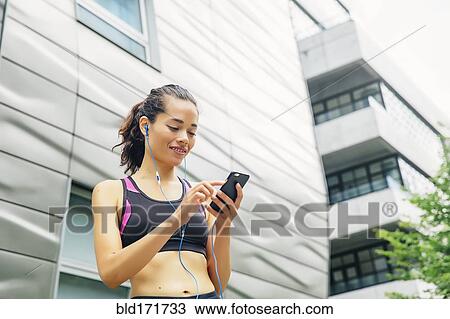 Mixed race athlete listening to mp3 player View Large Photo Image Stock Image - Mixed race athlete listening to mp3 player. Fotosearch