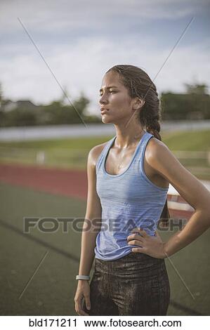 Mixed race athlete standing on sports field View Large Photo Image Stock Image - Mixed race athlete standing on sports field. Fotosearch