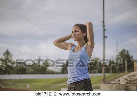 Mixed race athlete standing on sports field View Large Photo Image Stock Image - Mixed race athlete standing on sports field. Fotosearch
