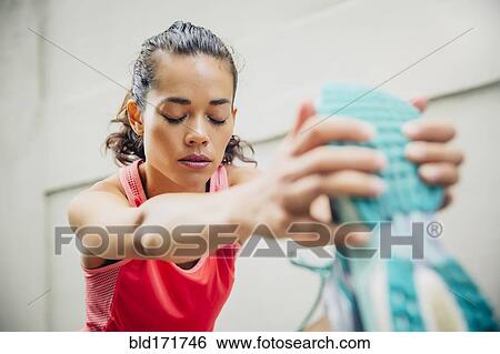 Mixed race athlete stretching outdoors View Large Photo Image Stock Photograph - Mixed race athlete stretching outdoors. Fotosearch