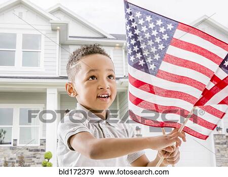 Stock Photo - Mixed race boy waving American flag. Fotosearch