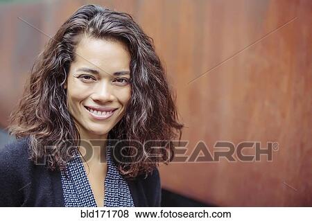 Mixed race businesswoman smiling View Large Photo Image Stock Photo - Mixed race businesswoman smiling . Fotosearch