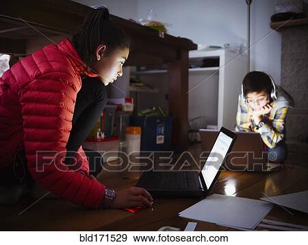 Mixed race children using laptops on floor View Large Photo Image Stock Photo - Mixed race children using laptops on floor. Fotosearch