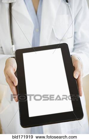 Stock Photo - Mixed race doctor showing digital tablet. Fotosearch