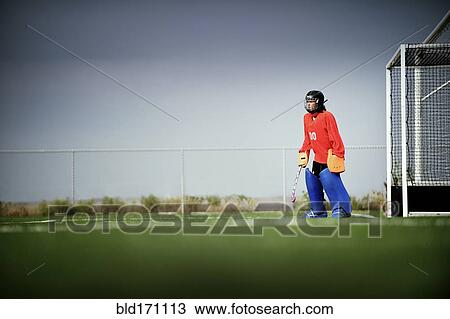 Mixed race field hockey goalie standing by goal View Large Photo Image Stock Image - Mixed race field hockey goalie standing by goal. Fotosearch