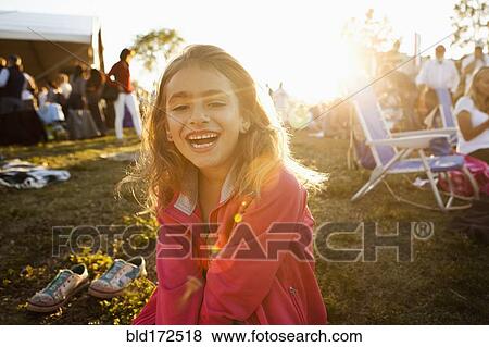 Stock Photo - Mixed race girl laughing in park. Fotosearch