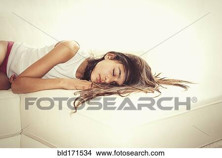 Mixed race girl sleeping on sofa View Large Photo Image Picture - Mixed race girl sleeping on sofa. Fotosearch