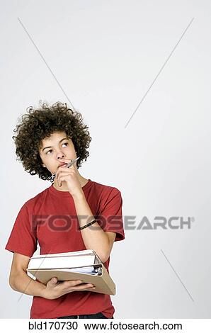 Mixed race student thinking with stack of books View Large Photo Image Stock Image - Mixed race student thinking with stack of books. Fotosearch